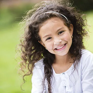 Curly-Haired-Girl-Smiling